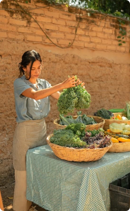 Woman selecting fresh organic kale at farmers market